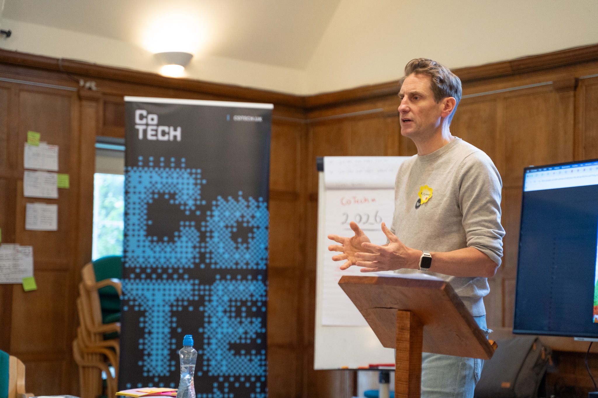 Photo of someone giving a talk at a CoTech event